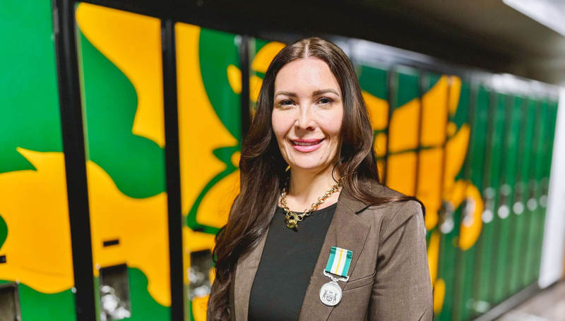 St. Clair College Prof. Stacey Robert-Tobin stands with her Queen Elizabeth II Medal for Good Citizenship