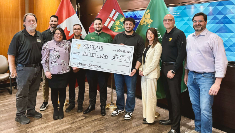 Members of St. Clair College's administration, support staff, student government and faculty unions present a cheque to United Way Windsor-Essex Chatham-Kent