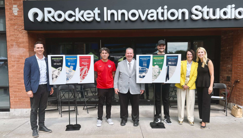 Partners from the University of Windsor, City of Windsor, Invest WindsorEssex, Rocket Innovation Studio, St. Clair College and WEtech Alliance unveil the banners in the Innovation District