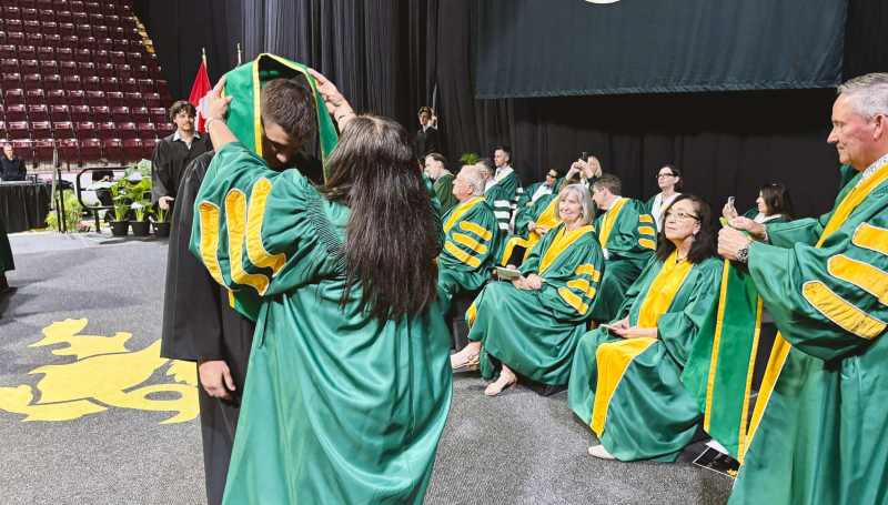 A student crossing the stage