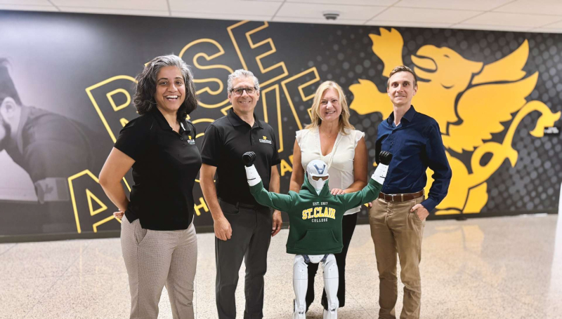 St. Clair College's Research and Innovation team poses with its new R1 humanoid robot