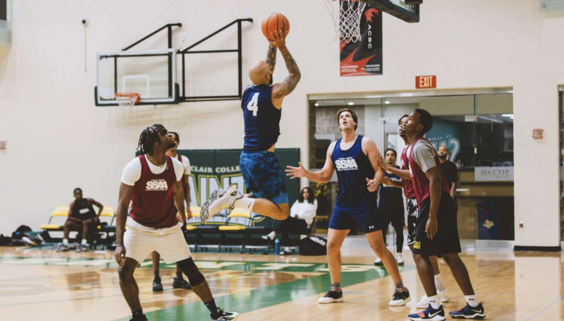 Man taking jump shot near basket