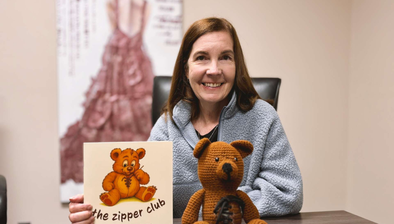 Former St. Clair College student Christine Montgomery holding her self-published book The Zipper Club.