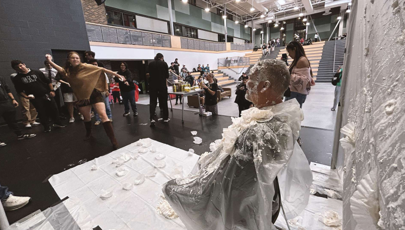 Student McKinley Lenehan throws a pie at Prof. Rick Beauchamp during the United Way Week fundraiser 