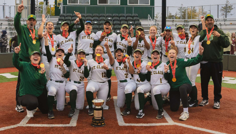 The St. Clair Saints Women's Softball team celebrates a gold medal