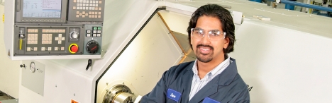 Man in front of CNC machine