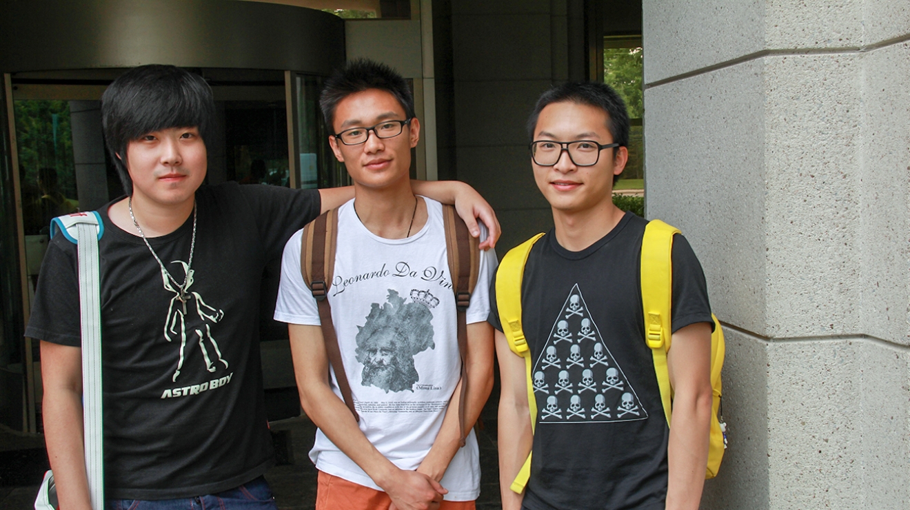 3 male students smiling at the camera.
