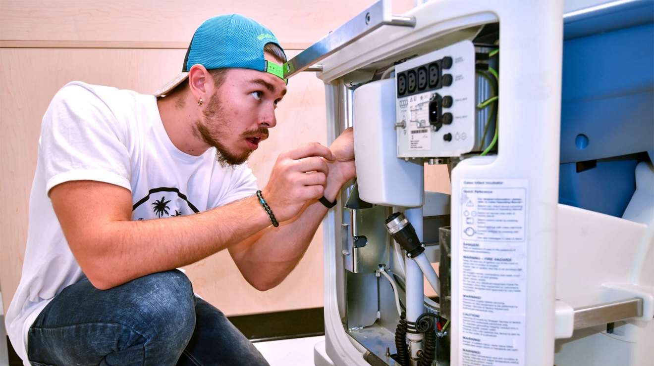 Male student working on machine
