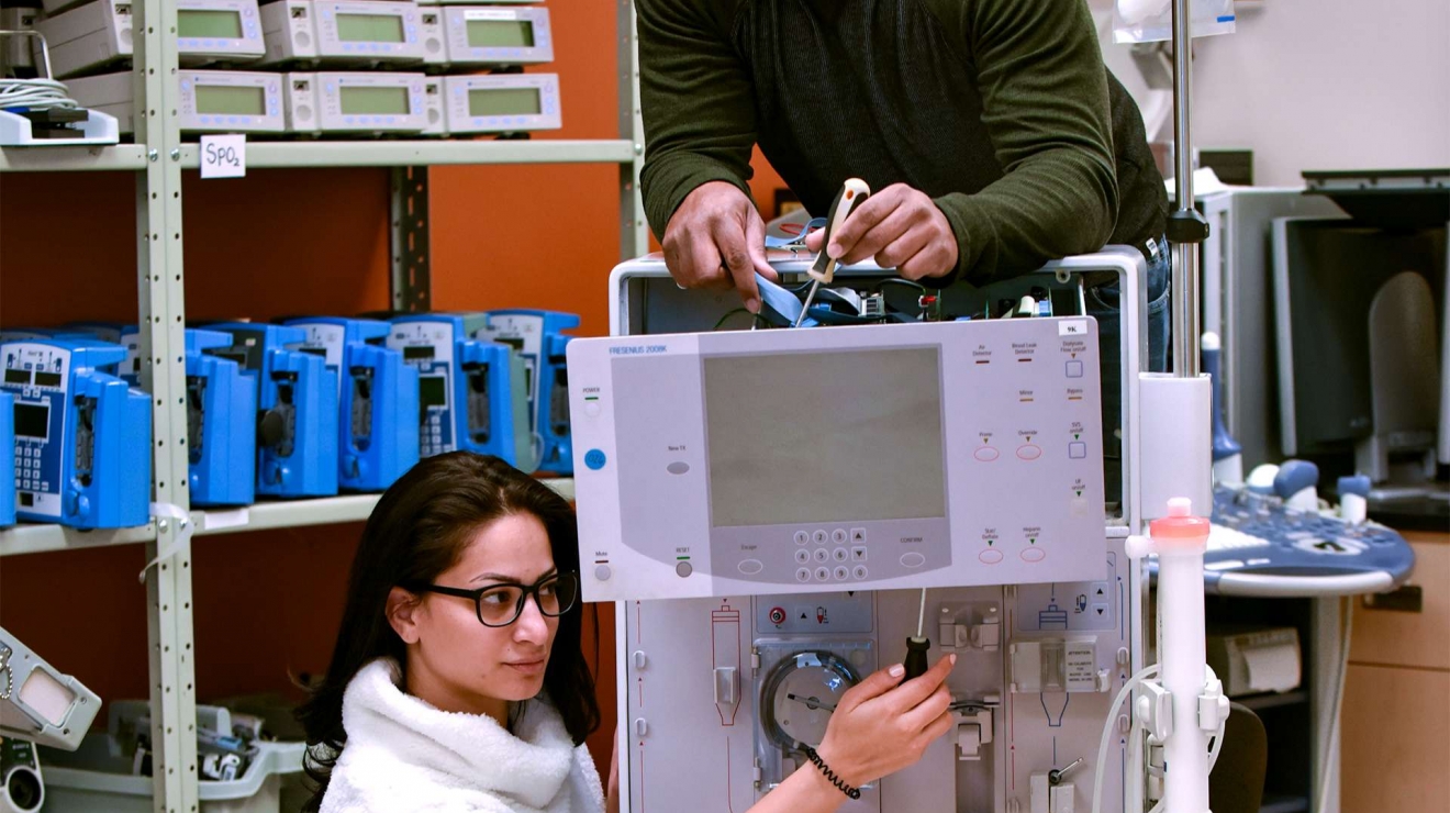 Students fixing machine