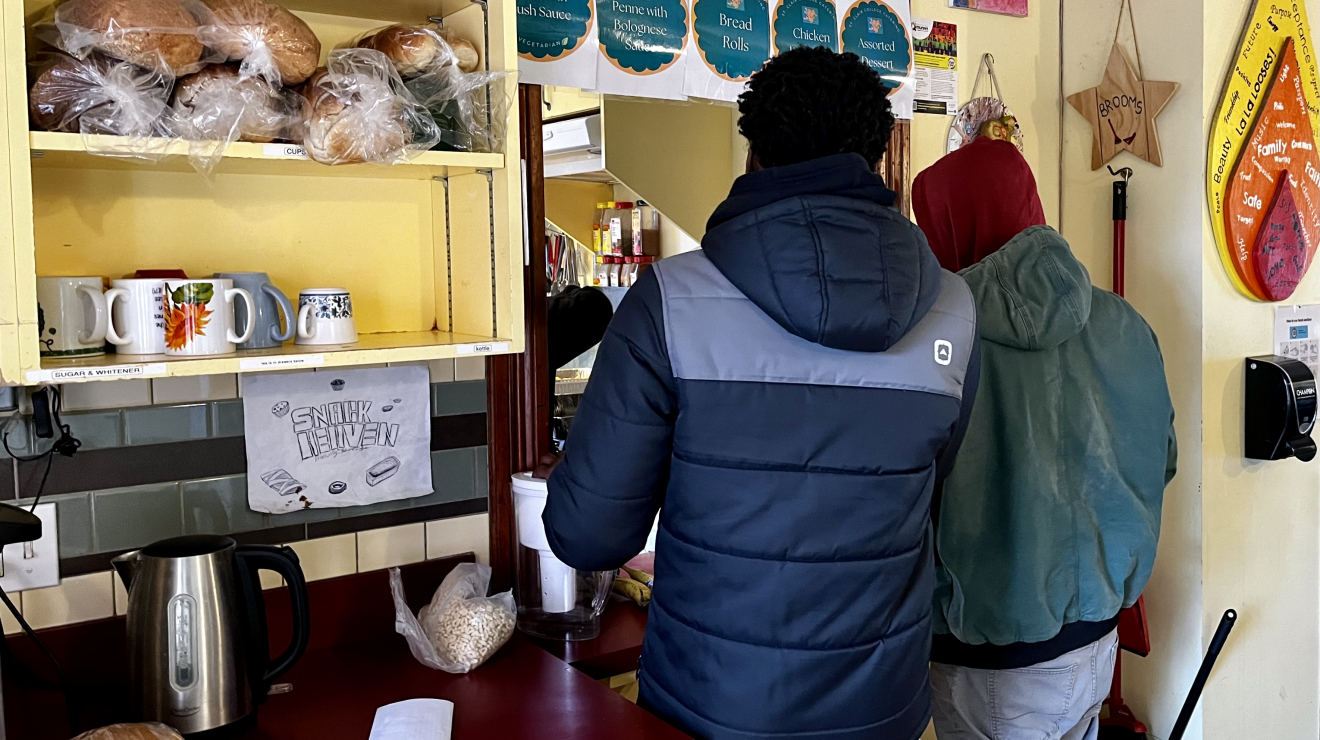 A couple people at food counter