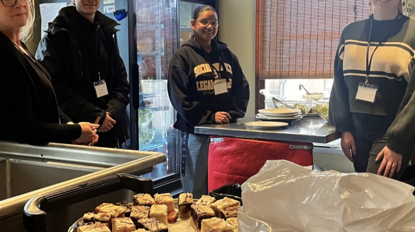 People near dessert tray